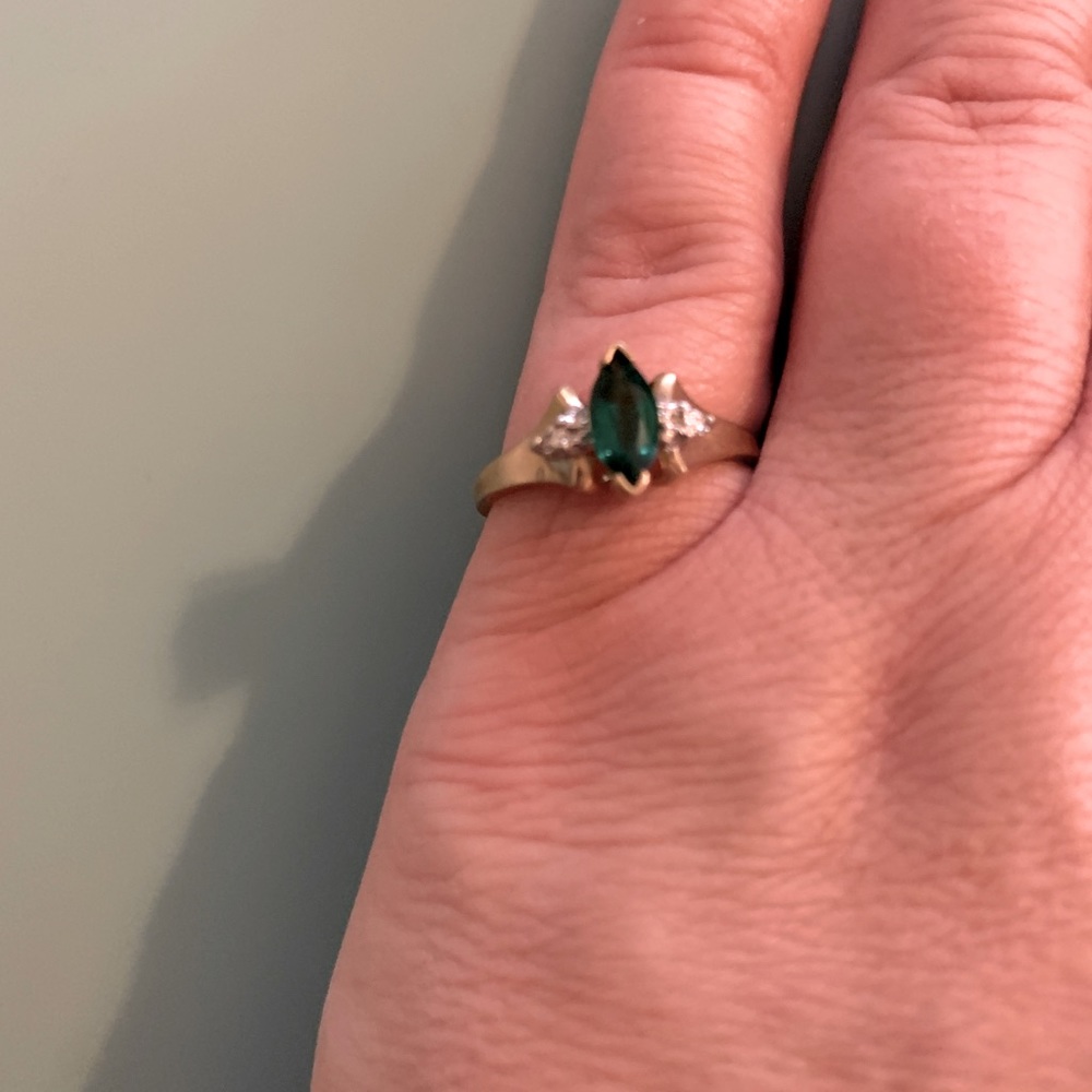 Emerald and diamond ring on gold band.